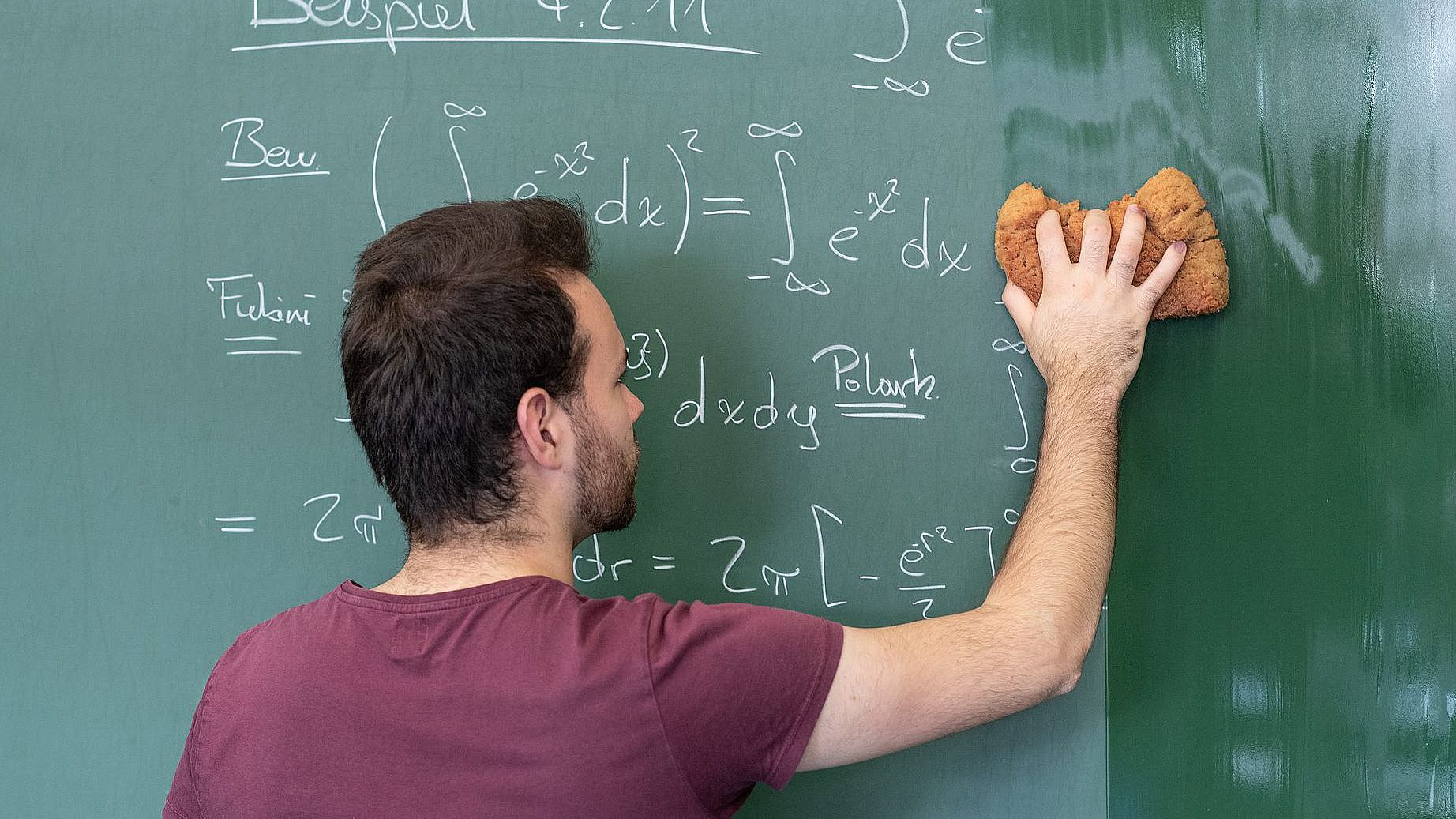 Lecturer wipes the blackboard